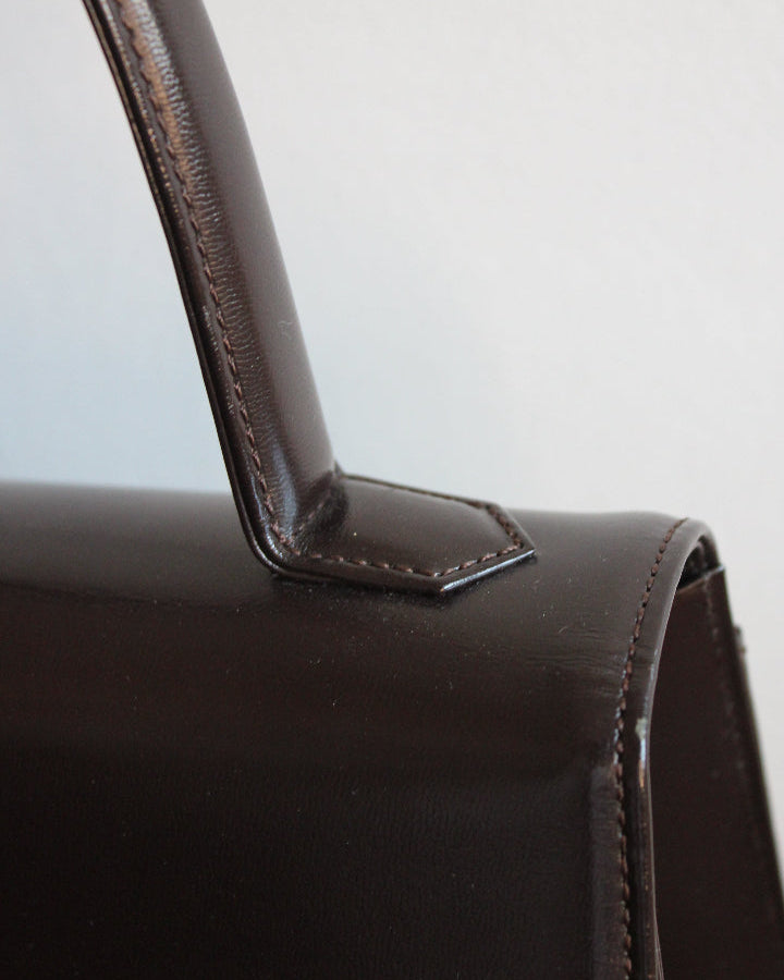 Close up of top handle on a vintage Yves Saint Laurent handbag