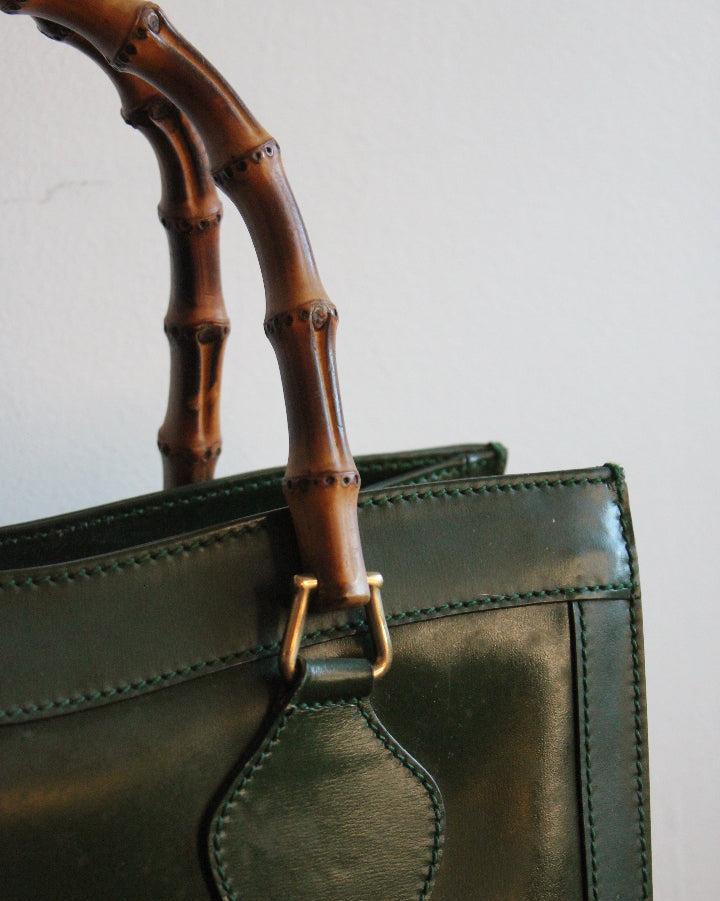 Stitching, golden hardware, and bamboo details of a medium green vintage Gucci Diana bag