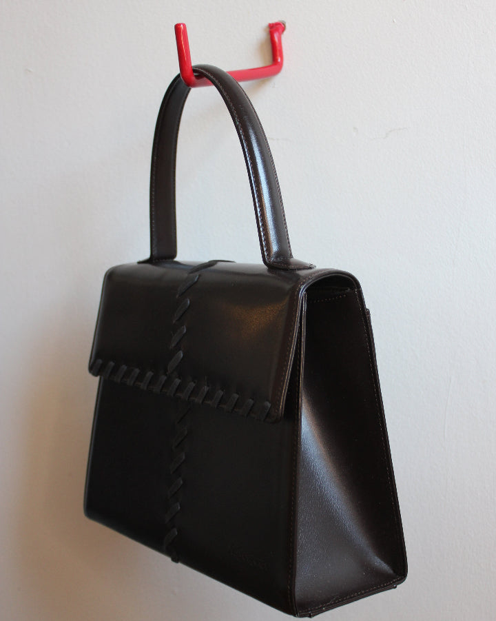 Side view of chocolate brown top handle YSL bag from the 70s