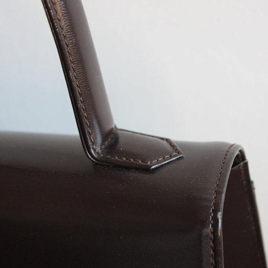 Close up of top handle on a vintage Yves Saint Laurent handbag