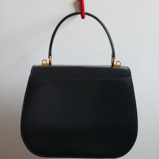 back of vintage navy gucci calfskin handbag with gold hardware