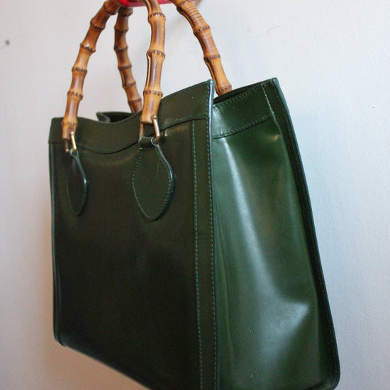 Side view of a medium sized, green leather, vintage Gucci Diana bag