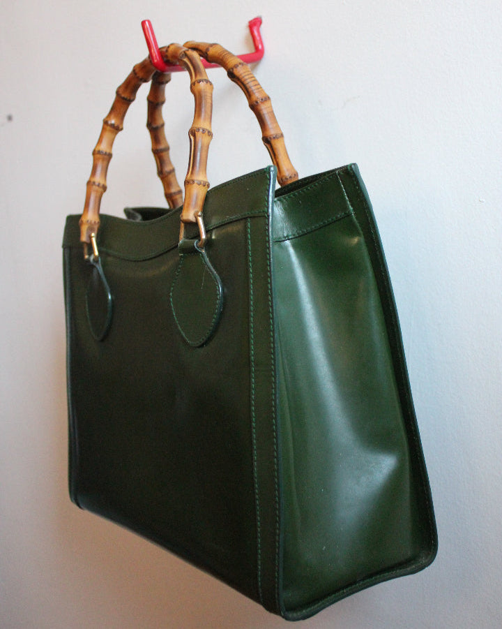Side view of a medium sized, green leather, vintage Gucci Diana bag